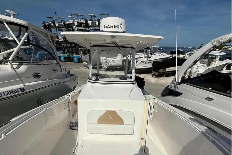  Yacht Photos Pics 2016 Edgewater 280CC boat docked among other vessels, featuring Garmin equipment.