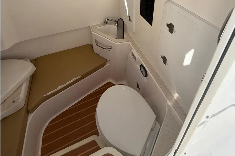  Yacht Photos Pics Interior of 2016 Edgewater 280CC boat featuring compact bathroom with sink and toilet.