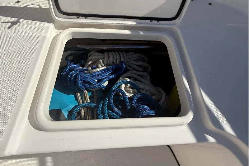  Yacht Photos Pics Open storage compartment on 2016 Edgewater 280CC boat with coiled ropes inside.