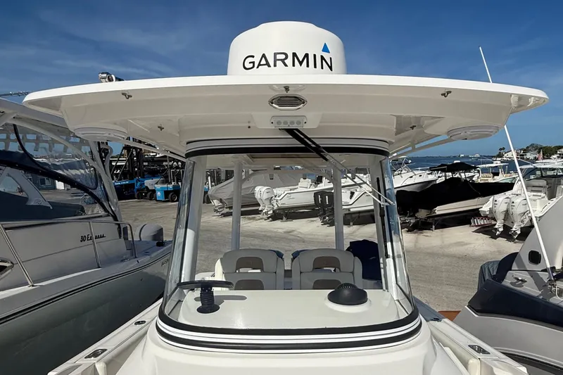  Yacht Photos Pics 2016 Edgewater 280CC boat with Garmin equipment, docked under clear blue skies.