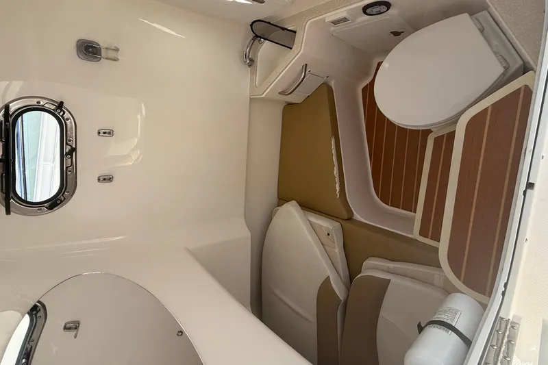  Yacht Photos Pics Interior of 2016 Edgewater 280CC boat featuring a compact bathroom with a porthole window.