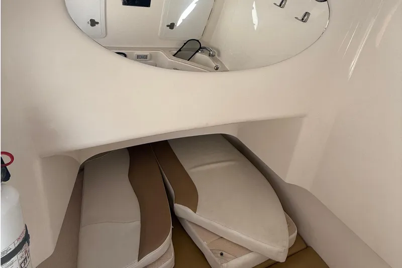  Yacht Photos Pics Interior cabin of 2016 Edgewater 280CC boat with cushions and mirror.