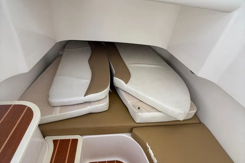  Yacht Photos Pics 2016 Edgewater 280CC cabin interior with stacked cushions and wooden accents.
