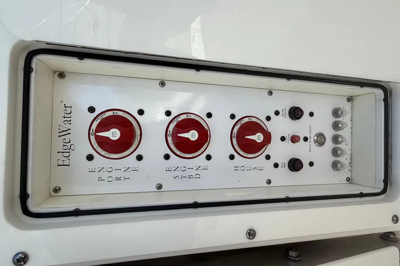  Yacht Photos Pics Control panel of a 2016 Edgewater 280CC boat with red switches and labels.