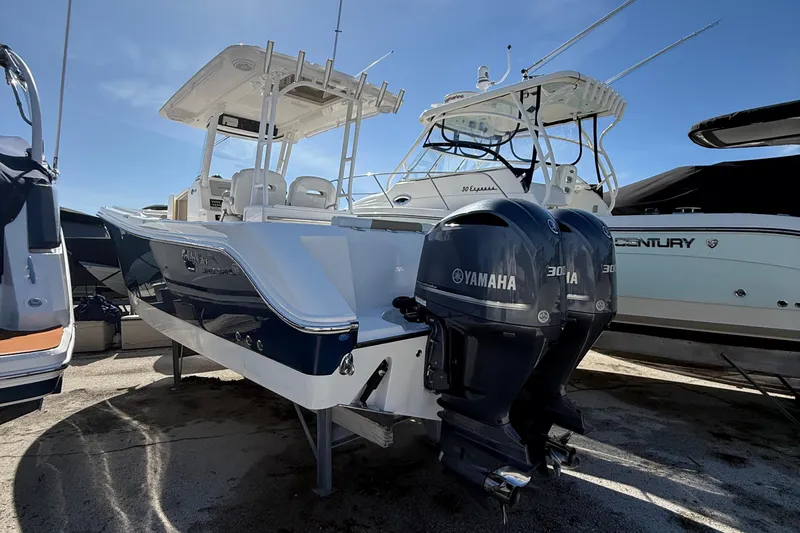  Yacht Photos Pics 2016 Edgewater 280CC boat with dual Yamaha engines, docked under clear blue sky.