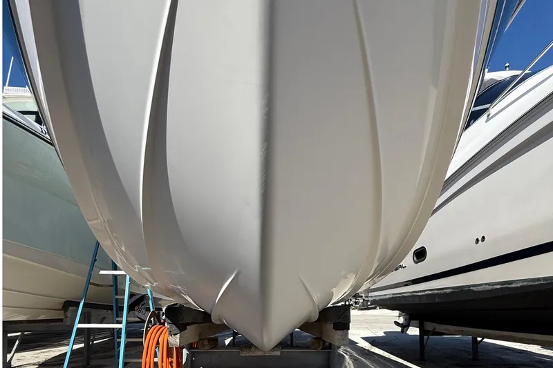  Yacht Photos Pics 2016 Edgewater 280CC boat hull on dry dock, surrounded by other boats.