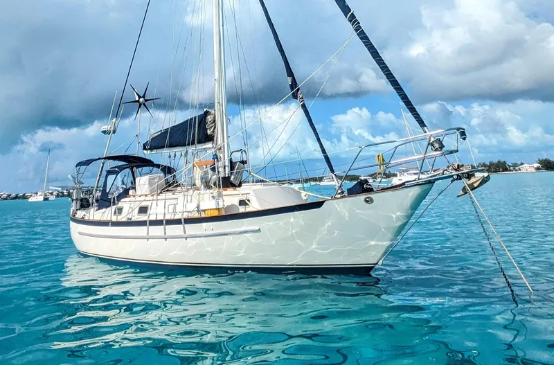 Remedy Yacht Photos Pics Sailboat Pacific Seacraft 37, 1995 model, anchored in clear blue water.