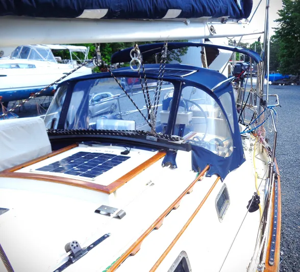 Remedy Yacht Photos Pics 1995 Pacific Seacraft 37 sailboat with solar panel and blue canopy.