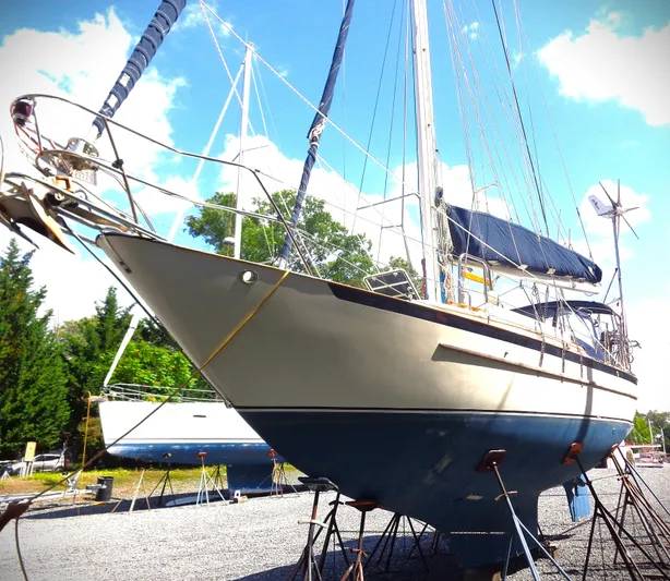 Remedy Yacht Photos Pics 1995 Pacific Seacraft 37 sailboat on stands, clear sky background.