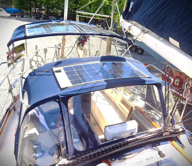 Remedy Yacht Photos Pics 1995 Pacific Seacraft 37 sailboat with solar panels on deck, docked outdoors.