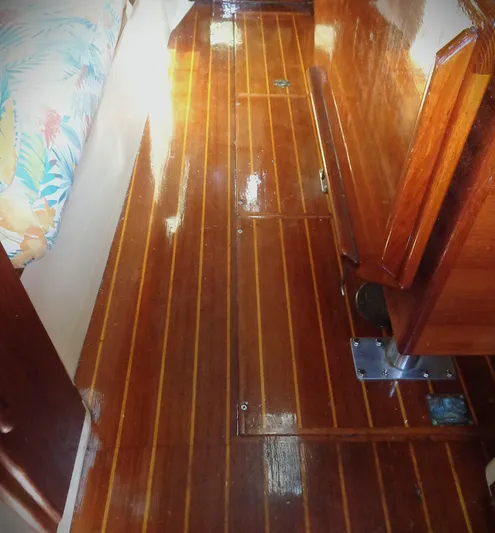 Remedy Yacht Photos Pics Polished wooden interior floor of 1995 Pacific Seacraft 37 sailboat.