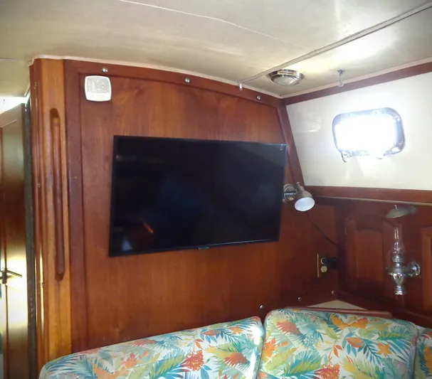 Remedy Yacht Photos Pics Interior of 1995 Pacific Seacraft 37 with TV and floral upholstery.