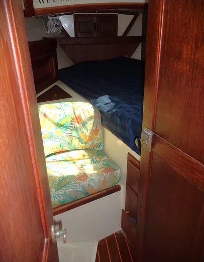 Remedy Yacht Photos Pics Cozy cabin interior of 1995 Pacific Seacraft 37 sailboat with floral seating and wooden finishes.