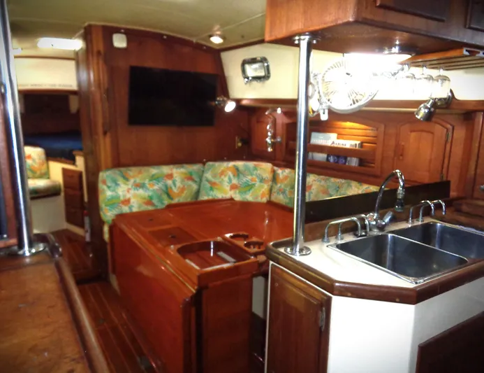Remedy Yacht Photos Pics Interior of 1995 Pacific Seacraft 37 sailboat with wood finish and cozy seating area.