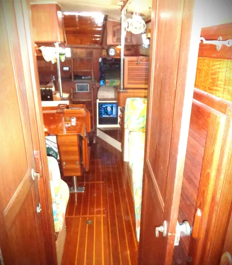 Remedy Yacht Photos Pics Interior of 1995 Pacific Seacraft 37 sailboat with wooden furnishings and cozy cabin layout.