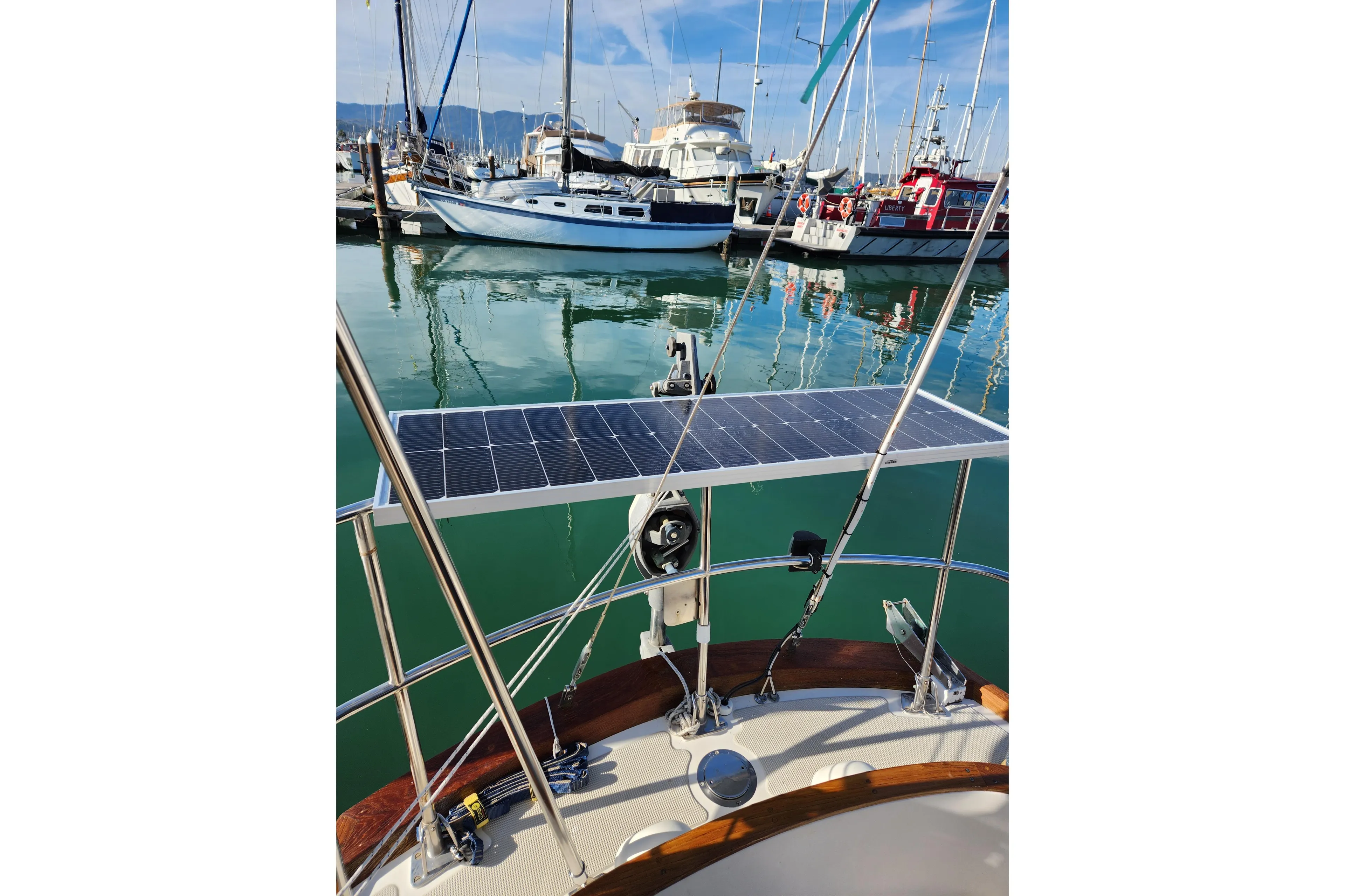 Sailboat with solar panel docked in marina, Mason 33 model, 1985.