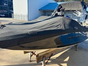 2016 MasterCraft X23 boat covered and docked outdoors.