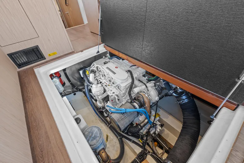 Unfiltered Yacht Photos Pics Engine compartment of 2023 Beneteau Swift Trawler 35, showcasing mechanical components and layout.