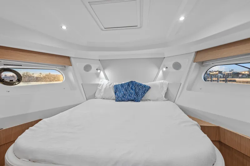 Unfiltered Yacht Photos Pics Luxurious cabin interior of 2023 Beneteau Swift Trawler 35 with cozy bedding.