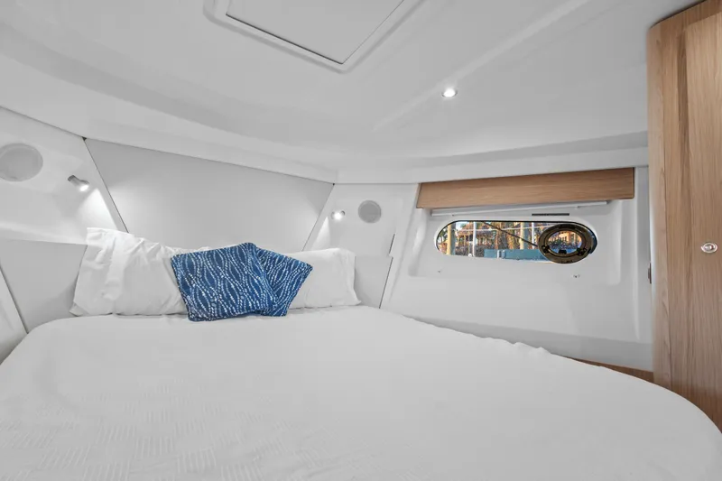 Unfiltered Yacht Photos Pics 2023 Beneteau Swift Trawler 35 cabin interior with bed and window view.