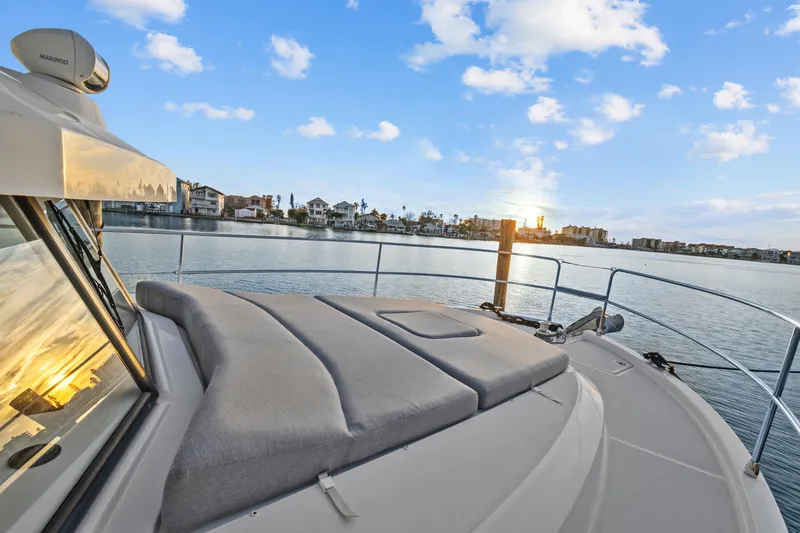 Unfiltered Yacht Photos Pics 2023 Beneteau Swift Trawler 35 on serene water at sunset.