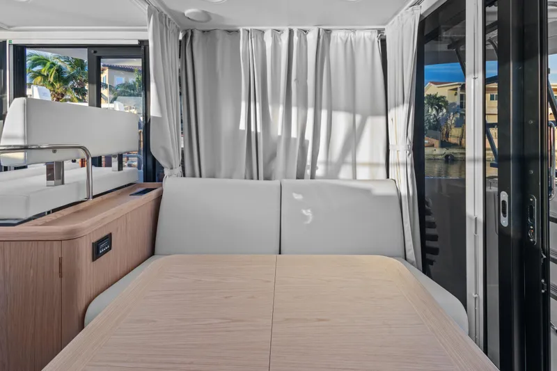 Unfiltered Yacht Photos Pics Interior of 2023 Beneteau Swift Trawler 35, featuring modern seating and large windows.