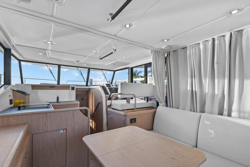 Unfiltered Yacht Photos Pics 2023 Beneteau Swift Trawler 35 interior with modern kitchen and seating area.