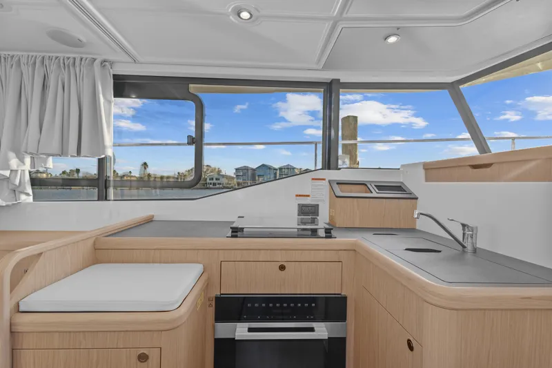 Unfiltered Yacht Photos Pics Interior of 2023 Beneteau Swift Trawler 35, featuring modern kitchen and scenic window view.
