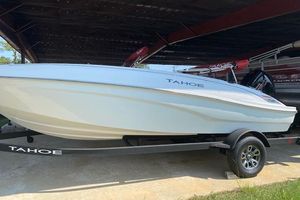 2026 Tahoe T18 boat on trailer under shelter, side view.