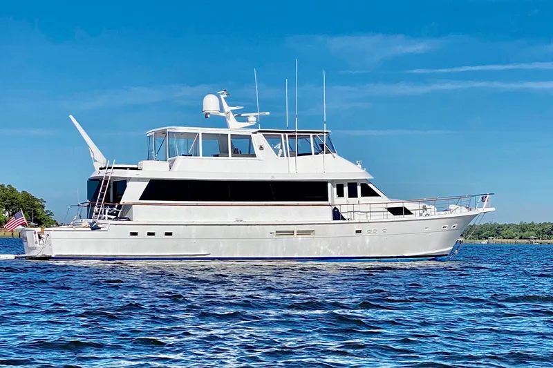 Nother Venture Yacht Photos Pics 1989 Hatteras 78 CPMY yacht cruising on a sunny day with clear blue skies.