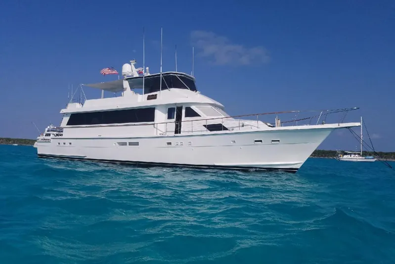 Nother Venture Yacht Photos Pics 1989 Hatteras 78 CPMY yacht on clear blue water under a sunny sky.