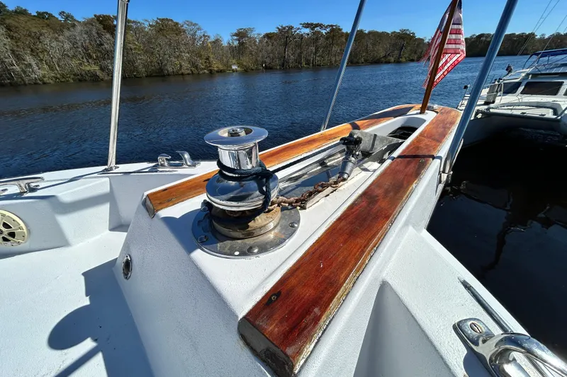 Nother Venture Yacht Photos Pics 1989 Hatteras 78 CPMY yacht deck with winch and American flag on a sunny day.