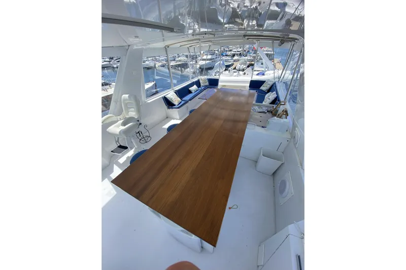 Nother Venture Yacht Photos Pics Spacious deck of 1989 Hatteras 78 CPMY yacht with wooden table and seating.
