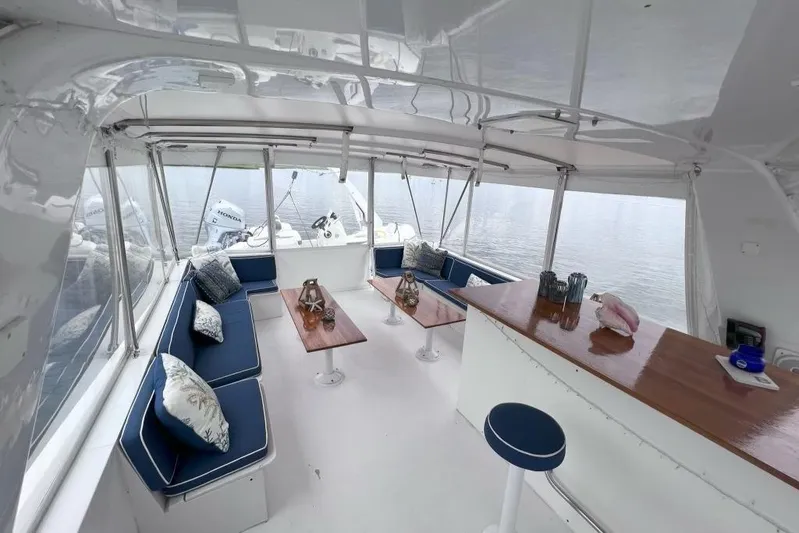 Nother Venture Yacht Photos Pics Luxurious interior of 1989 Hatteras 78 CPMY yacht with elegant seating and wooden tables.