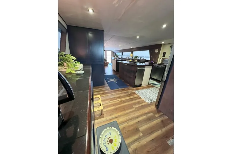 Nother Venture Yacht Photos Pics Interior of 1989 Hatteras 78 CPMY yacht with modern kitchen and wooden flooring.