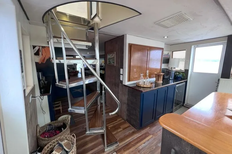 Nother Venture Yacht Photos Pics Interior of 1989 Hatteras 78 CPMY yacht with spiral staircase and modern decor.