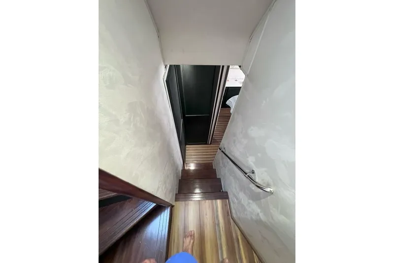 Nother Venture Yacht Photos Pics Staircase inside 1989 Hatteras 78 CPMY yacht with wooden steps and handrail.