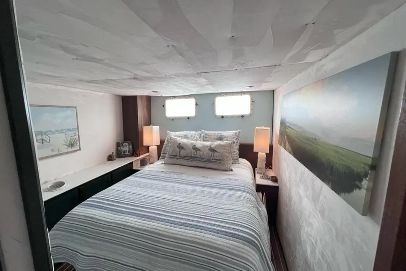 Nother Venture Yacht Photos Pics Cozy bedroom in 1989 Hatteras 78 CPMY yacht with nautical decor and soft lighting.