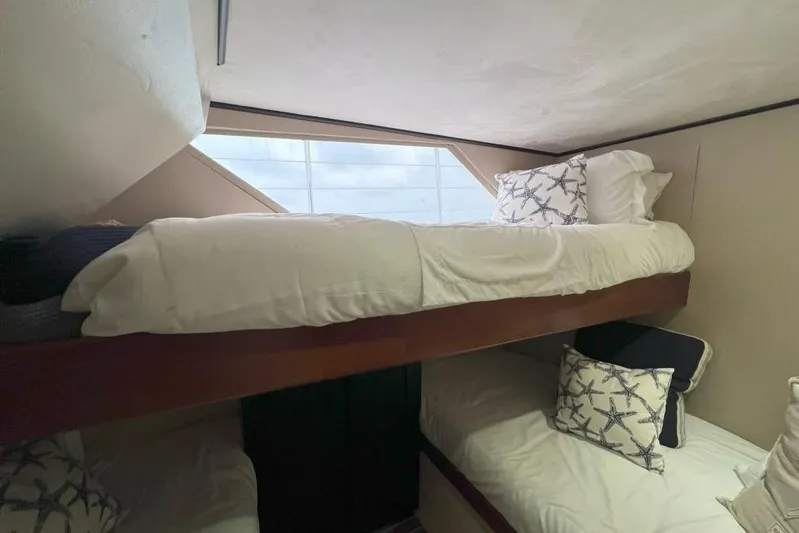 Nother Venture Yacht Photos Pics Bunk beds in 1989 Hatteras 78 CPMY yacht cabin with starfish-patterned pillows.