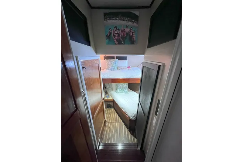 Nother Venture Yacht Photos Pics Interior of 1989 Hatteras 78 CPMY yacht with bunk beds and wooden flooring.