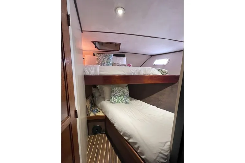 Nother Venture Yacht Photos Pics Cozy bunk beds in 1989 Hatteras 78 CPMY yacht cabin with wooden accents.