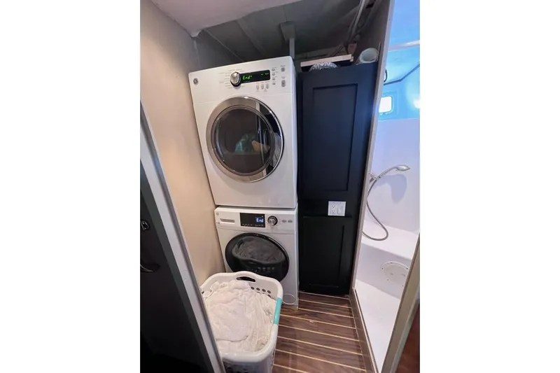 Nother Venture Yacht Photos Pics Laundry area on 1989 Hatteras 78 CPMY yacht with stacked washer and dryer.