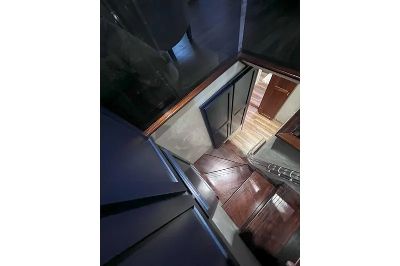 Nother Venture Yacht Photos Pics Interior view of 1989 Hatteras 78 CPMY yacht, featuring wooden stairs and modern design.