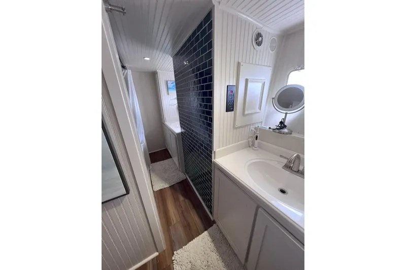 Nother Venture Yacht Photos Pics Luxurious bathroom on 1989 Hatteras 78 CPMY yacht with modern fixtures and elegant design.