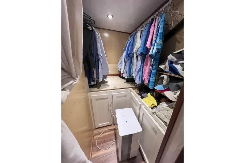 Nother Venture Yacht Photos Pics Closet on 1989 Hatteras 78 CPMY yacht with clothes, hats, and a dehumidifier.