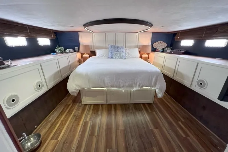 Nother Venture Yacht Photos Pics Luxurious bedroom interior of 1989 Hatteras 78 CPMY yacht with wood flooring.