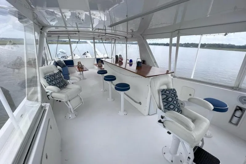 Nother Venture Yacht Photos Pics Luxurious interior of 1989 Hatteras 78 CPMY yacht with seating and panoramic views.