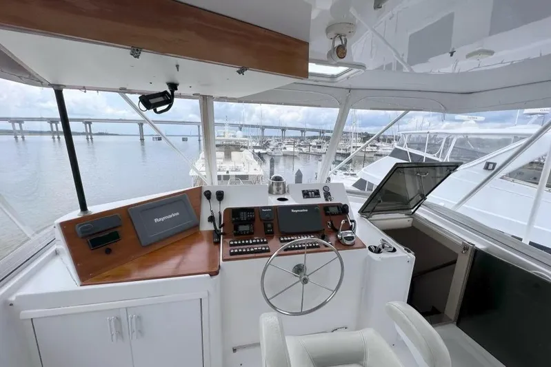 Nother Venture Yacht Photos Pics Cockpit of 1989 Hatteras 78 CPMY yacht with navigation equipment and marina view.