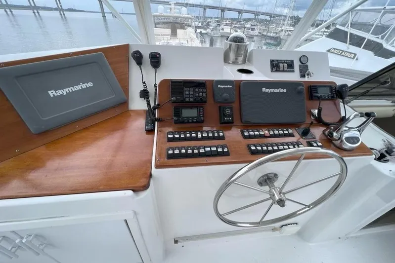 Nother Venture Yacht Photos Pics Cockpit of 1989 Hatteras 78 CPMY yacht with Raymarine navigation equipment and steering wheel.