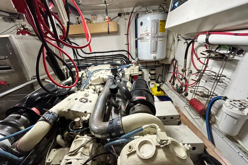 Nother Venture Yacht Photos Pics Engine room of 1989 Hatteras 78 CPMY yacht with visible machinery and wiring.